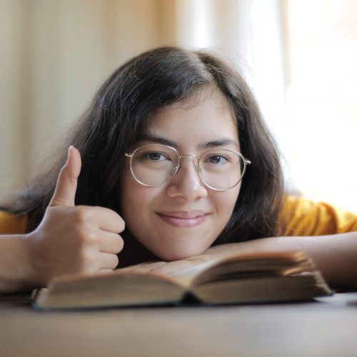 selective-focus-photo-of-woman-smiling-while-doing-thumbs-up-3807770